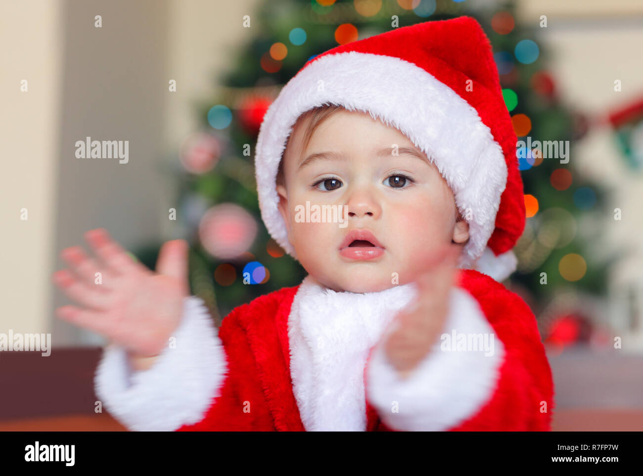 Holiday background with cute Santa Claus Christmas tree decorative ornament  & gift box in snow over abstract defocus lights | Stock image | Colourbox