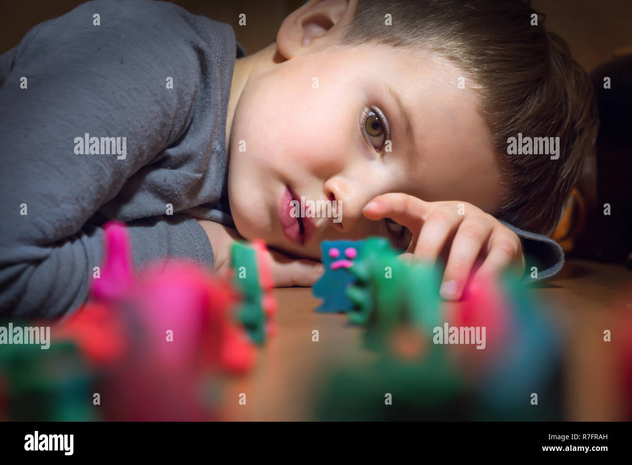 Boy and toys. Colorful toys made from plasticine. Stock Photo