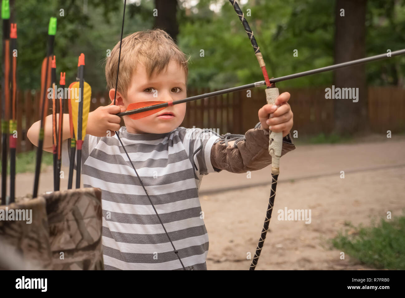 Boy with a bow and arrow. Children and sports Stock Photo Alamy