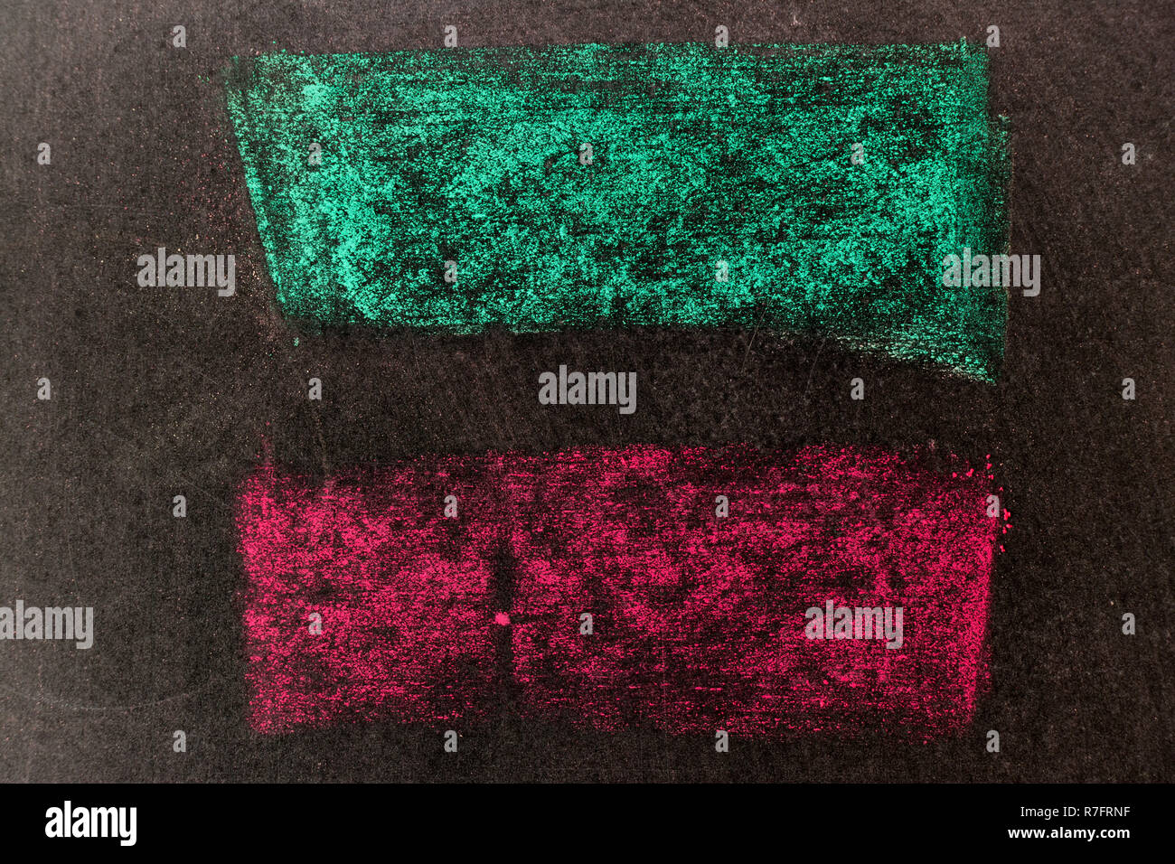 Green and red chalk drawing in line shape on black board background