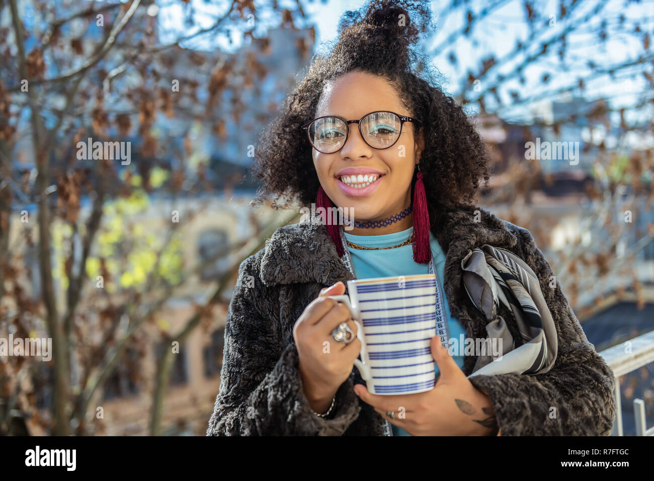 Smiling dark-skinned lady having light blue eyeshadow Stock Photo