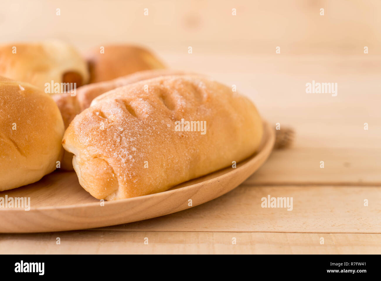 bread in wood plate on the table Stock Photo