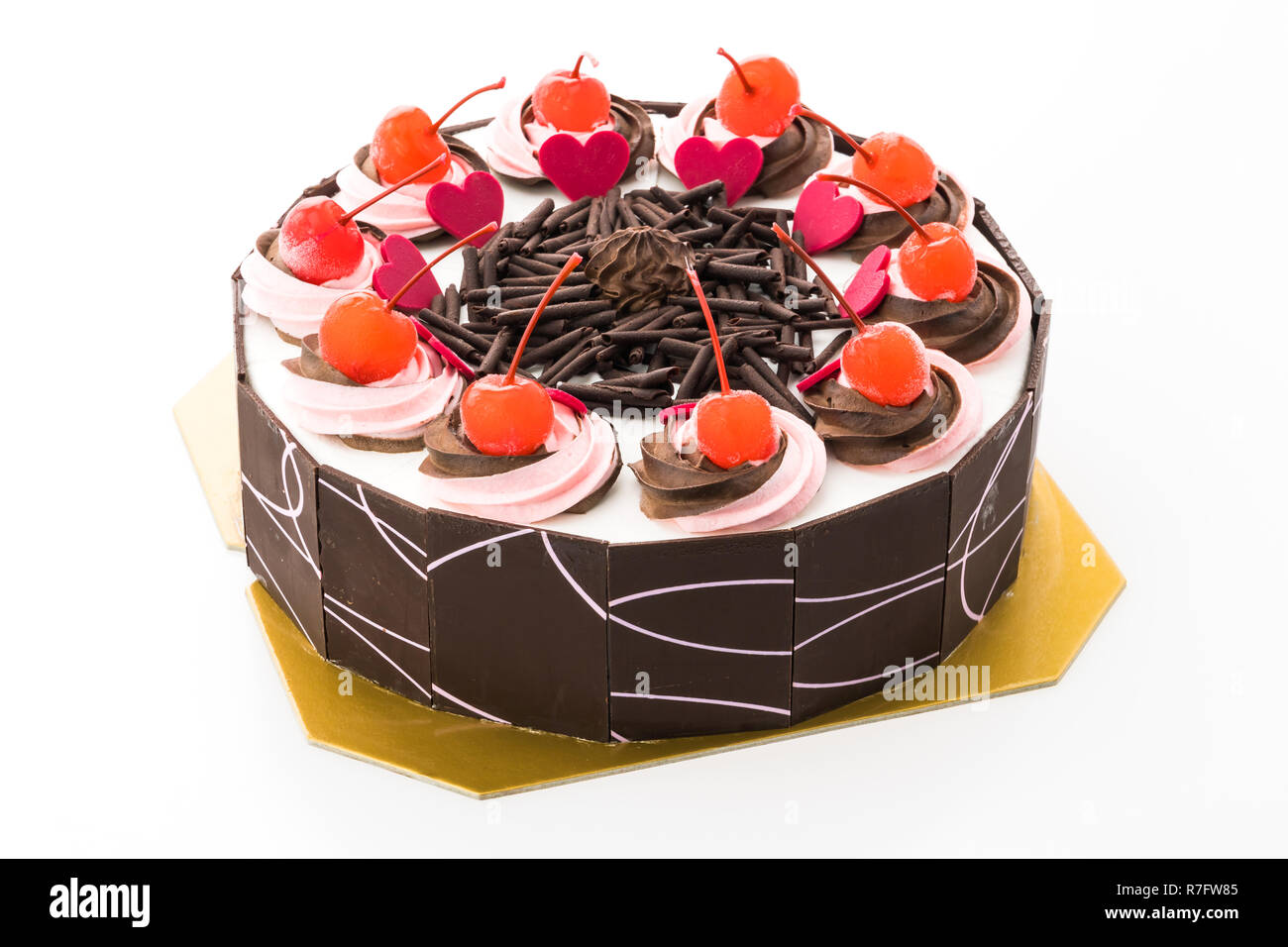 Chocolate cake with cherry on top isolated on white background Stock Photo
