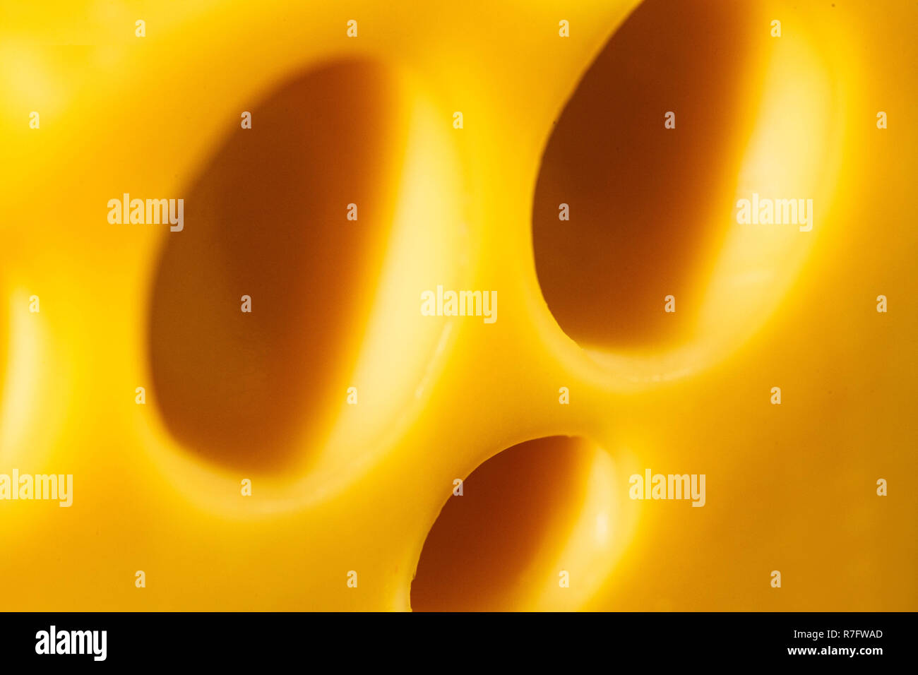 Closeup of holes in Swiss cheese Stock Photo Alamy