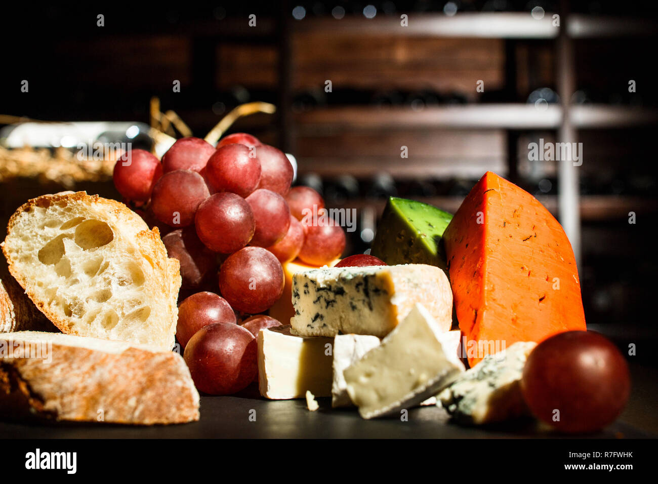 Delicious fresh baked bread lies on plate with cheese Stock Photo