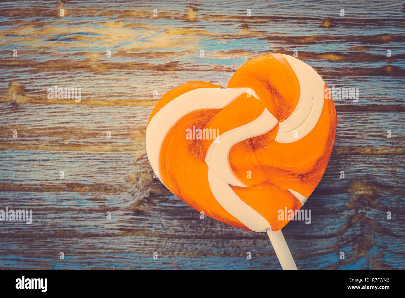 Heart lollipop candy on wood background - Vintage effect style pictures