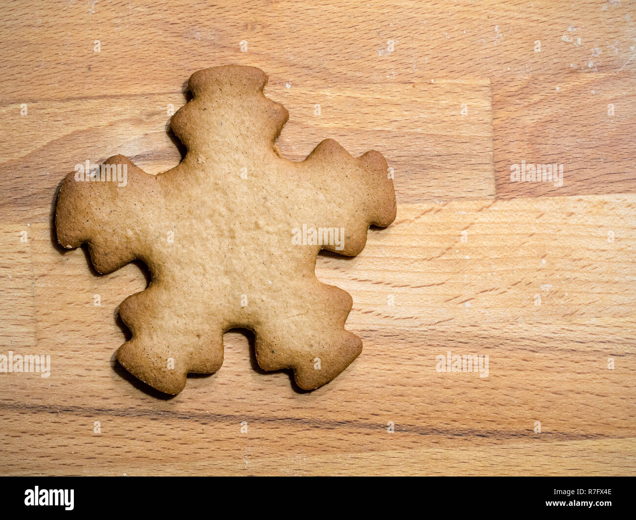 Christmas gingerbread star-shape cookie placed on wooden board Stock Photo