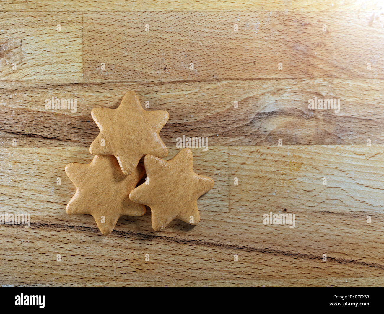 Christmas gingerbread star-shape cookies placed on wooden board Stock Photo