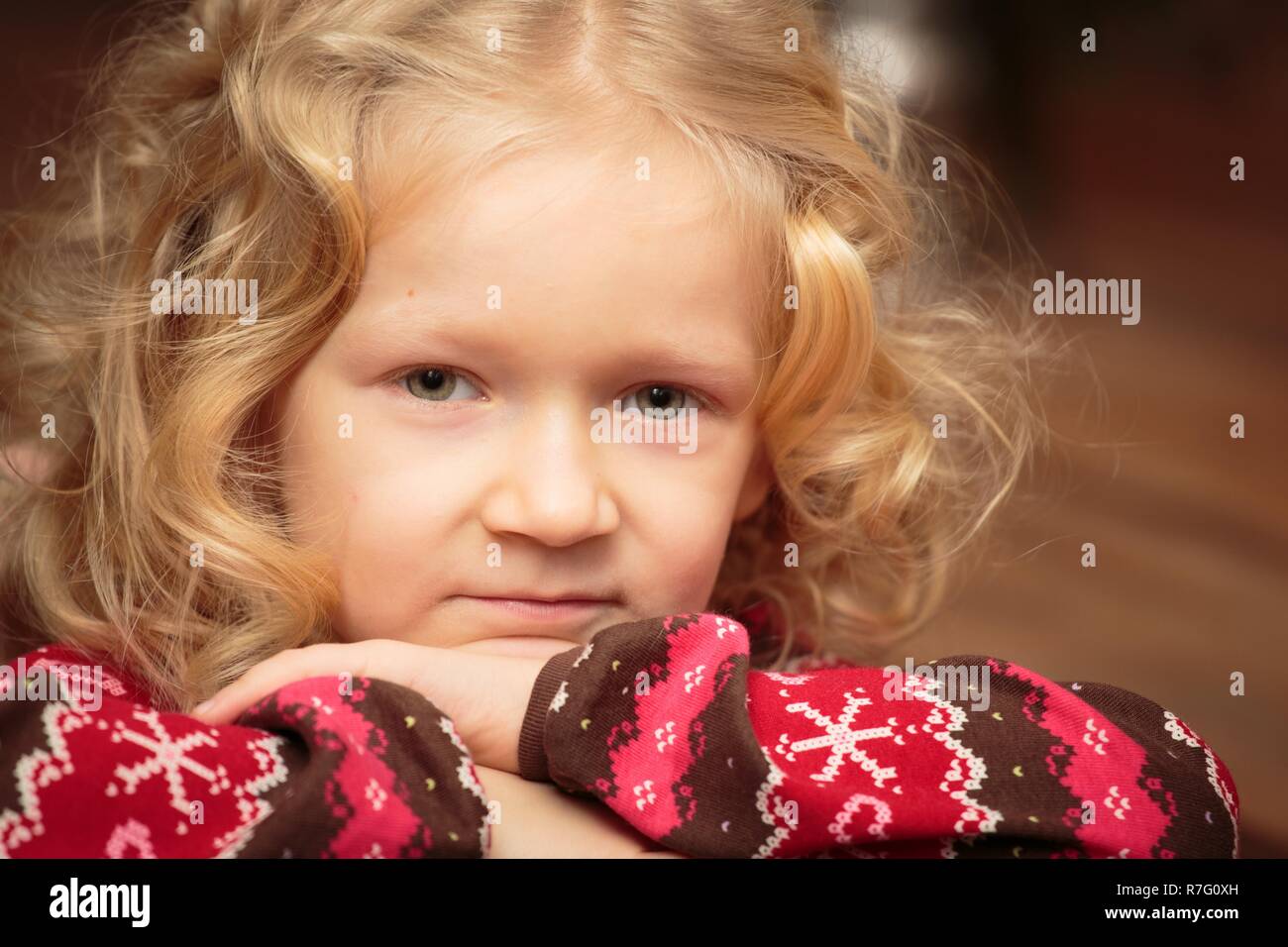 portrait of smiling curly little girl indoors Stock Photo