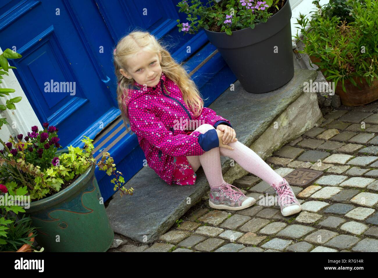 beautiful little girl sitting on the porch in Bergen, Norway Stock ...