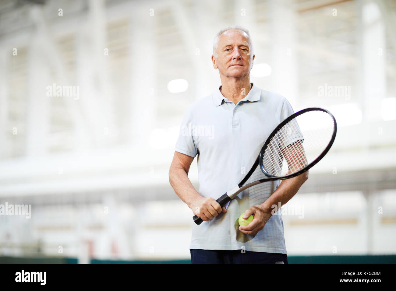Tennis player in sports center Stock Photo
