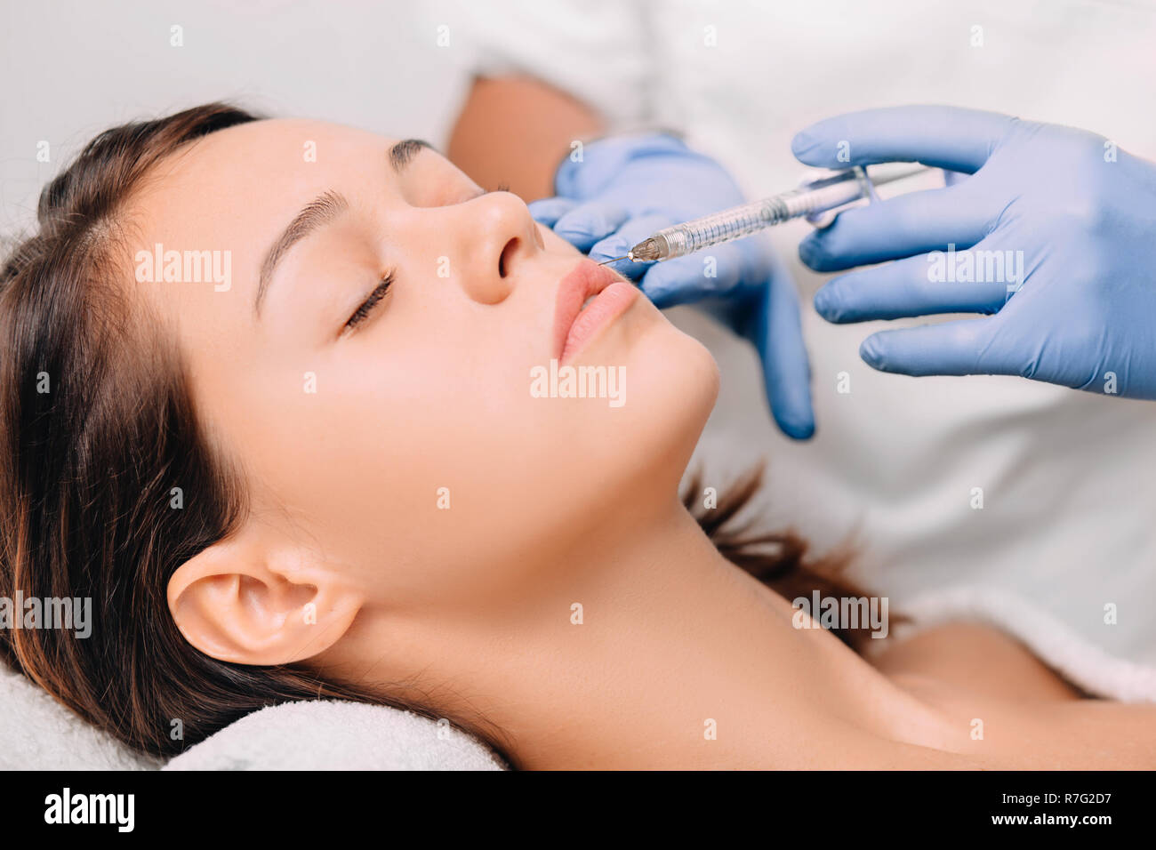 woman having lip injection for lip augmentation Stock Photo
