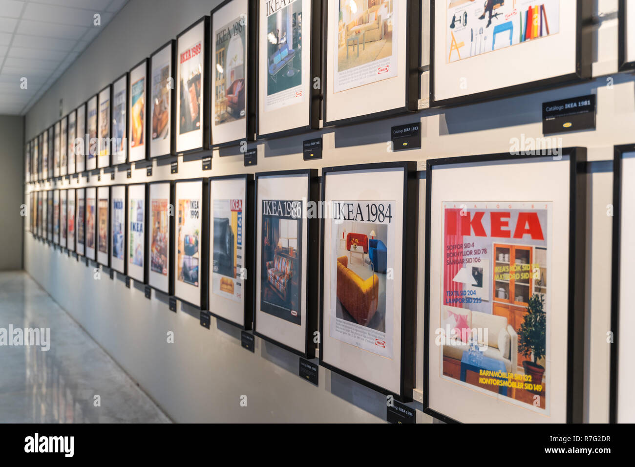 Valencia,Spain - December 09, 2018: Ikea store lot in Alfafar, Valencia. Exhibition of the old Ikea catalogs, framed on the wall. Vintage Ikea gallery Stock Photo