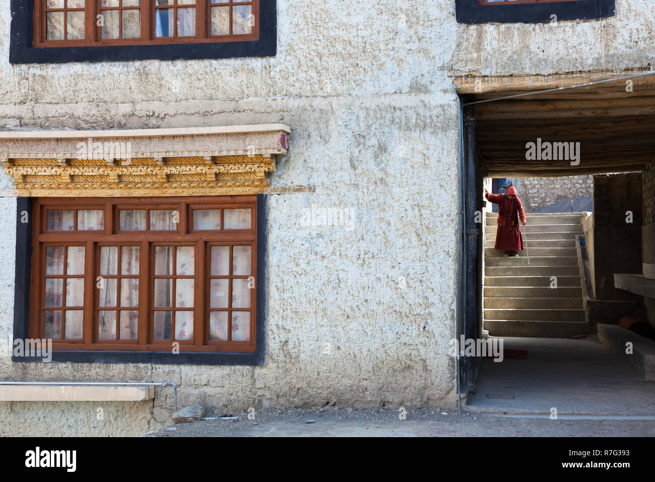 Monk walking down the stairs in Lamayuru Monastery, Ladakh, Jammu and Kashmir, India Stock Photo