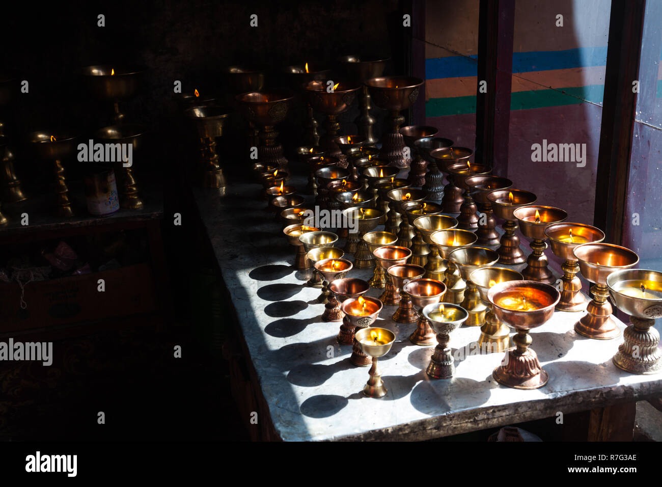 Traditional Buddhist butter lamps in Lamayuru Monastery, Ladakh, Jammu and Kashmir, India Stock Photo
