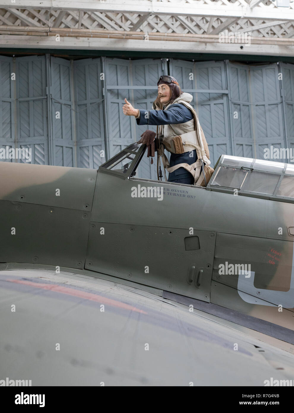Model of world war 2 RAF fighter pilot emerging from a Spitfire fighter at the Imperial War Museum, Duxford, Cambridgeshire,uk Stock Photo