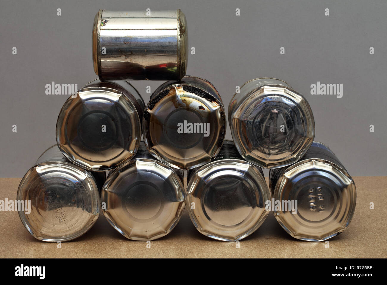 The bunch of full, bulging old tin cans - sick food - garbage Stock Photo