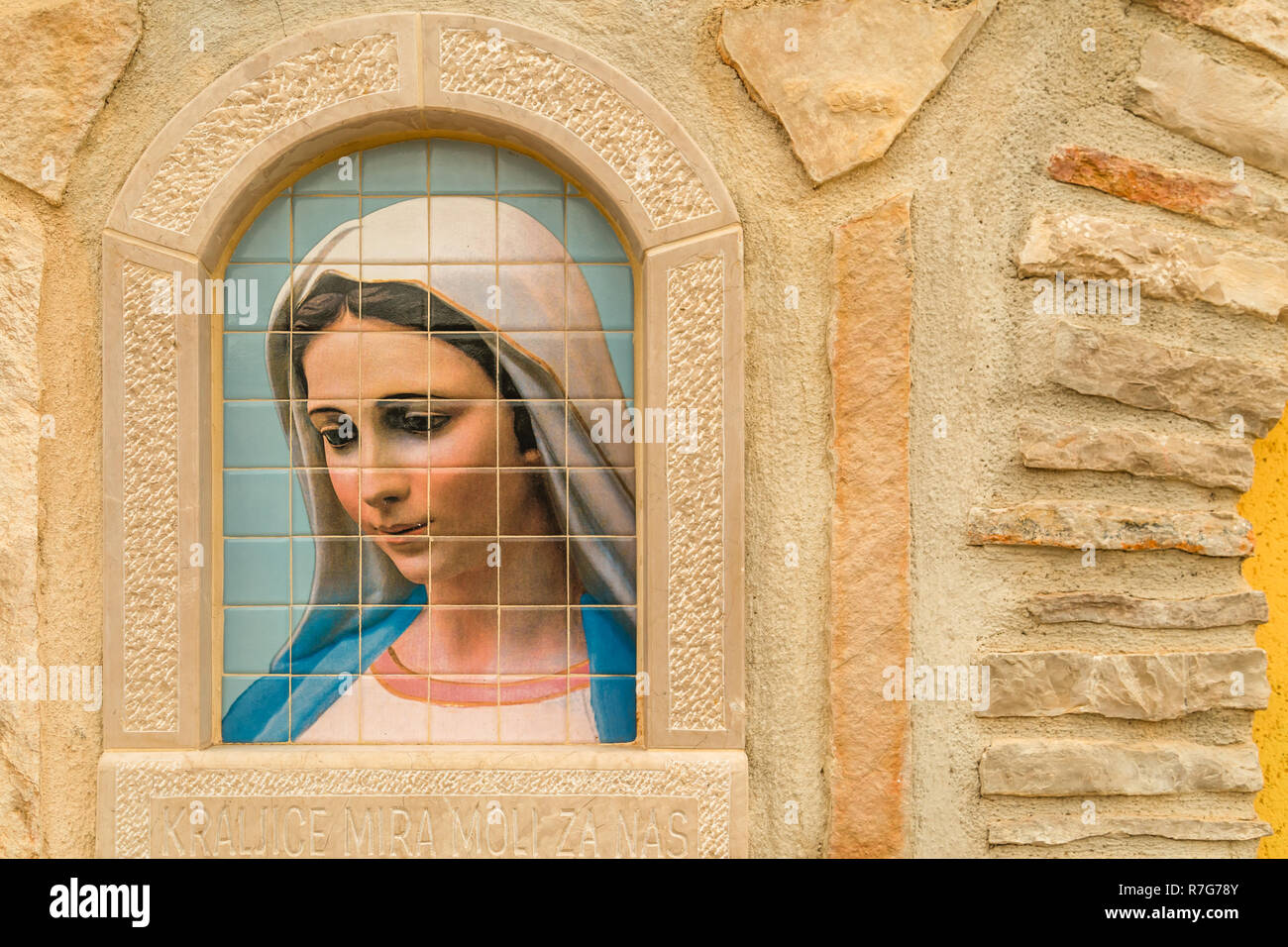 Medjugorje, Bosnia and Herzegovina - November 3, 2018: sunlight is enlightening painting of the Blessed Virgin Mary on tiles Stock Photo