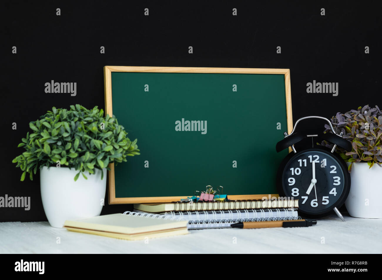 Back to school and education concept idea, green chalkboard with pile ...
