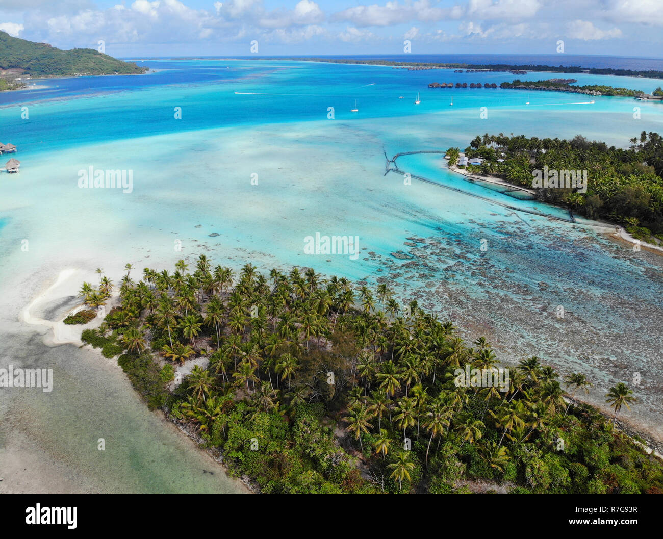 Aerial panoramic landscape view of the island of Bora Bora in French Polynesia with the Mont Otemanu mountain surrounded by a turquoise lagoon, motu a Stock Photo