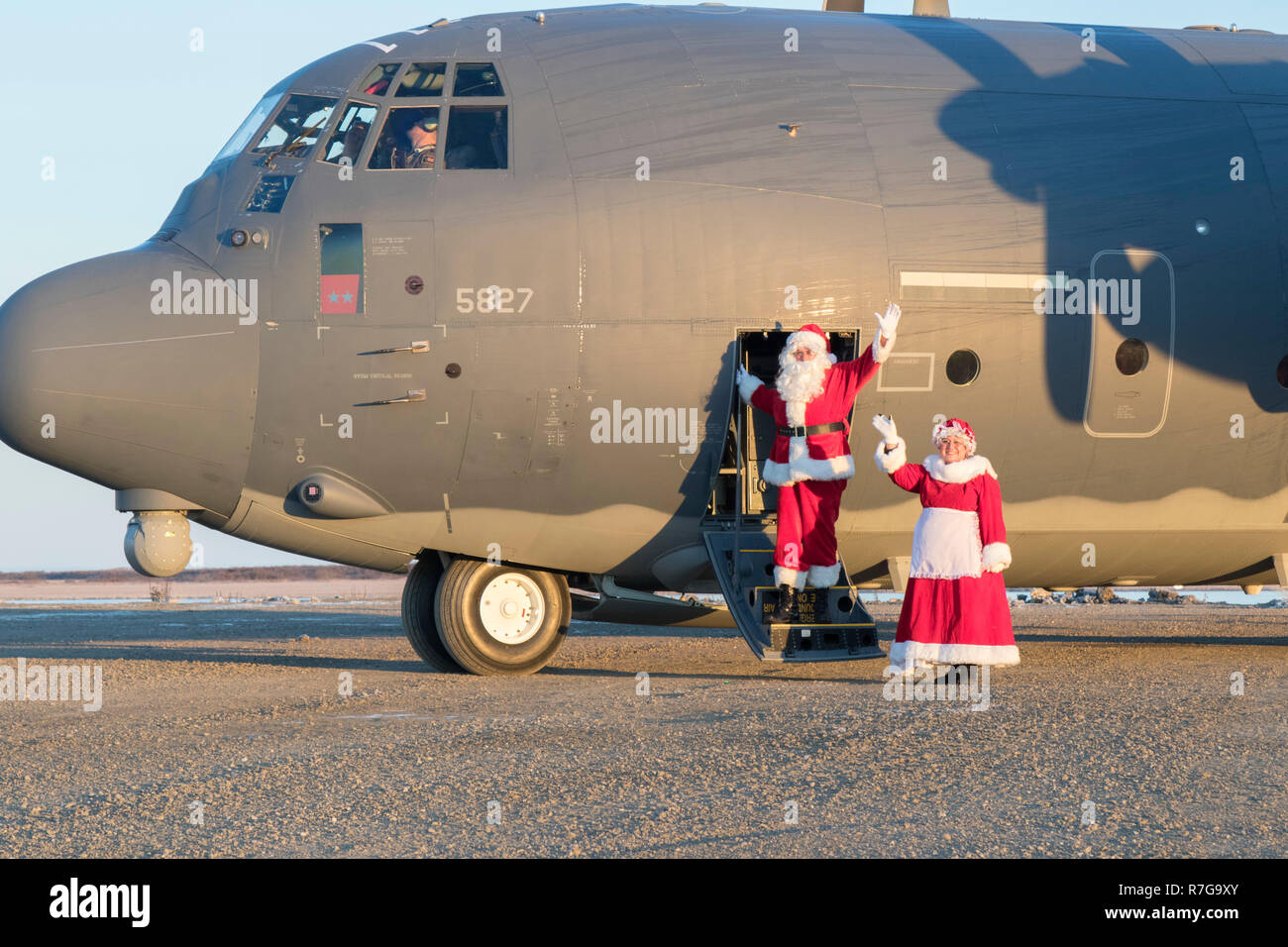 Santa Claus and Mrs Claus waves as they arrive aboard an Alaska Air