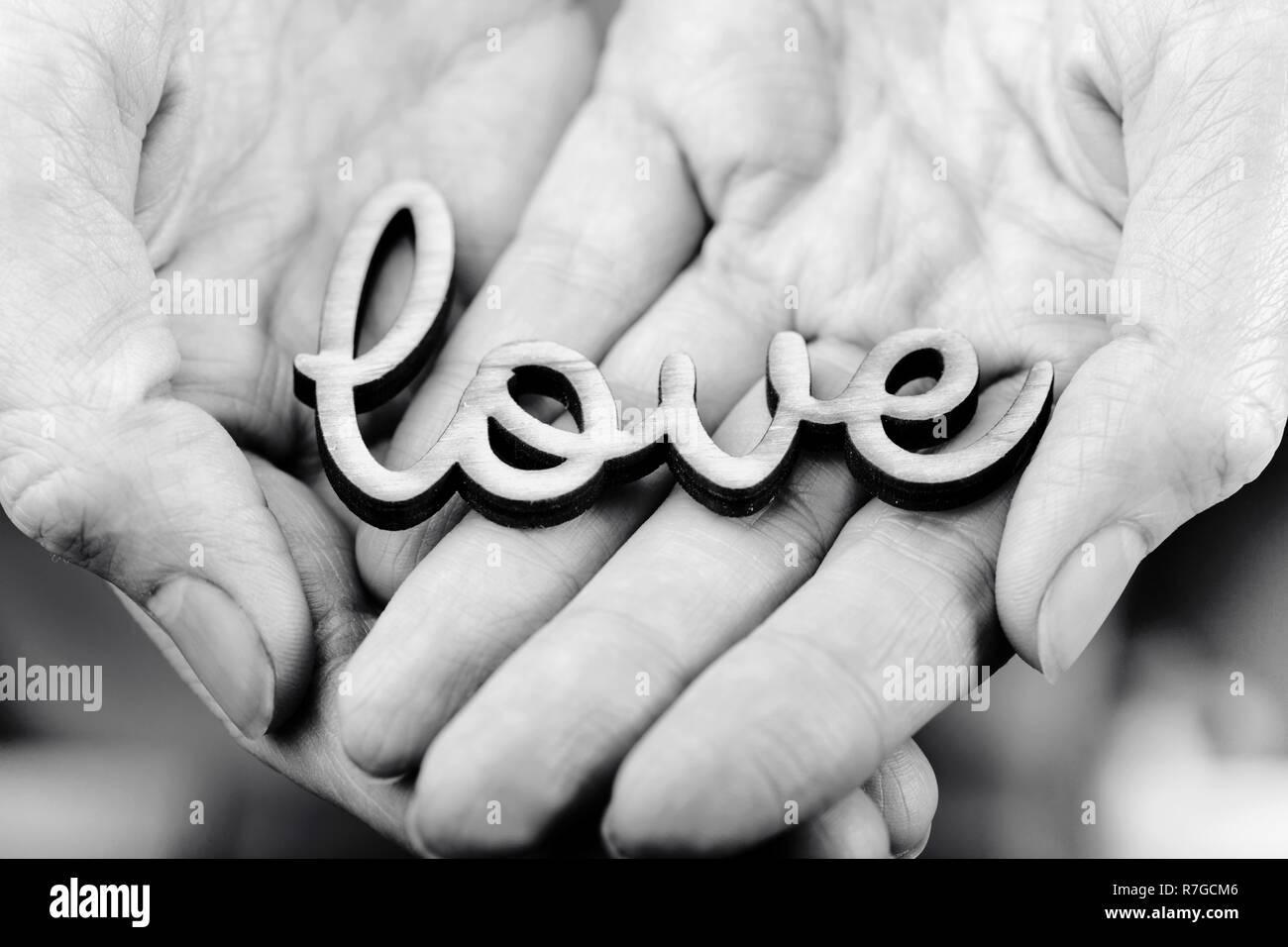 hands holding word love Stock Photo - Alamy