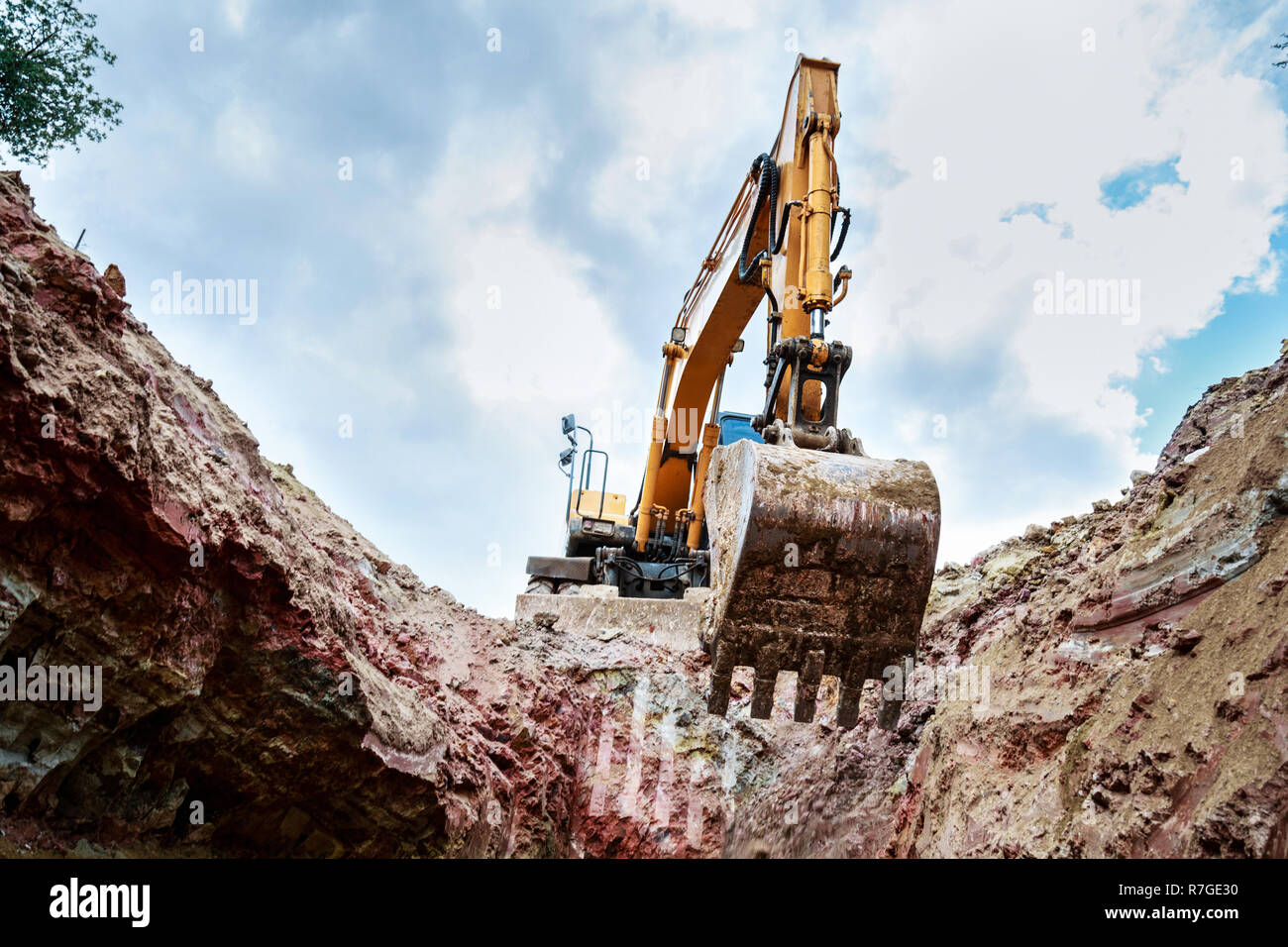 Excavator digging a trench for the pipeline. Excavation Stock Photo - Alamy