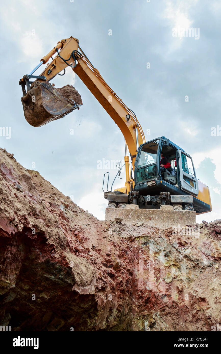 Excavator digging a trench for the pipeline. Excavation Stock Photo - Alamy