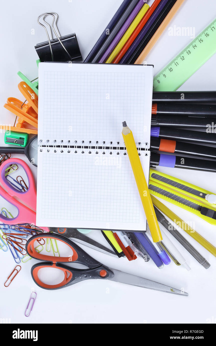 opened Notepad on office supplies on white background Stock Photo