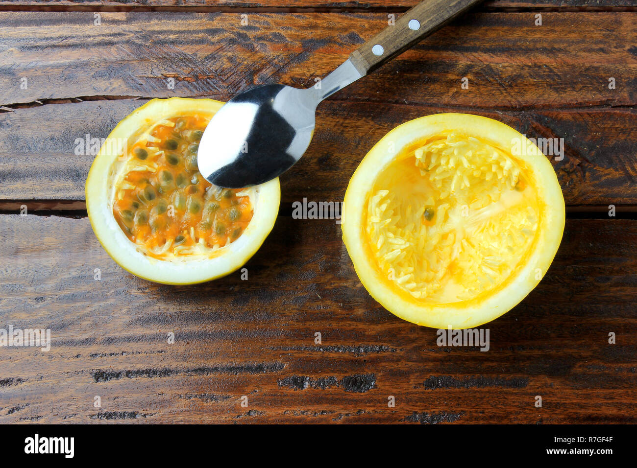 Stainless Steel Spoon Removing Yellow Passion Fruit Pulp On Wooden Table Top View Stock Photo Alamy