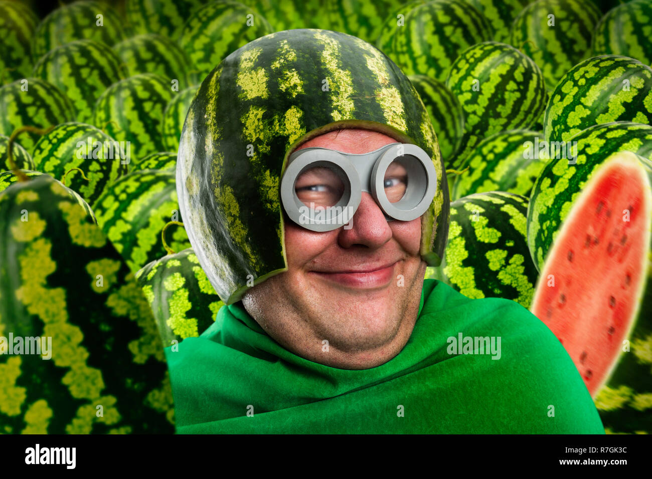 Crazy man in watermelon helmet and googles, parasitic caterpillar or worm, fruit instead of head Stock Photo