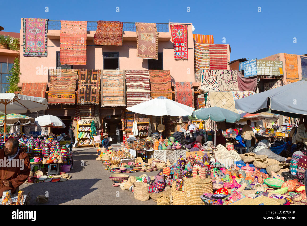 Marrakech souk - colourful goods and carpets for sale in the souks, Marrakech medina, Marrakesh Morocco Africa Stock Photo