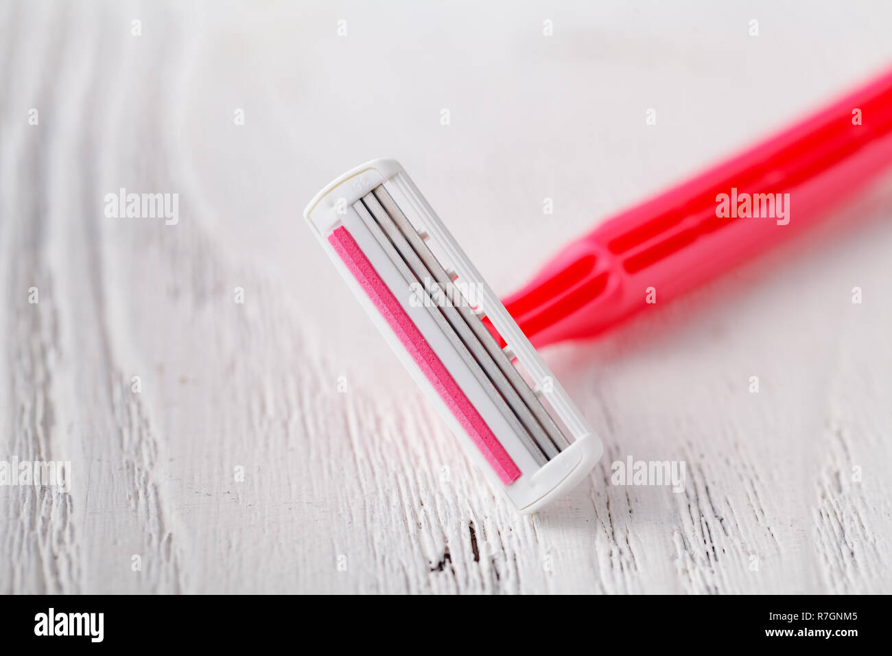 Pink razor on white background Stock Photo - Alamy