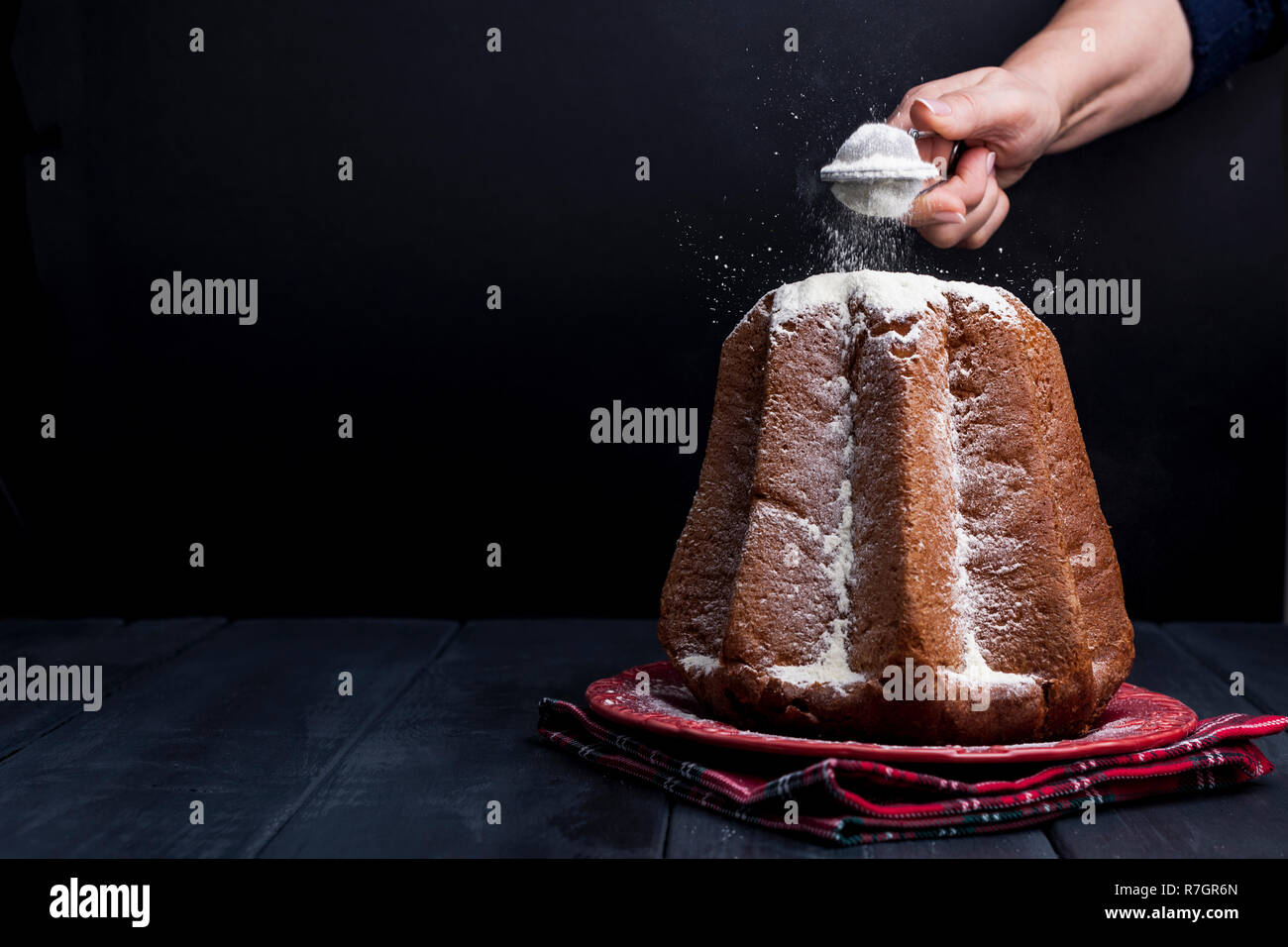 https://c8.alamy.com/comp/R7GR6N/christmas-baking-in-italy-delicious-festive-bread-with-powdered-sugar-and-lemon-cream-view-on-black-background-free-space-for-text-R7GR6N.jpg