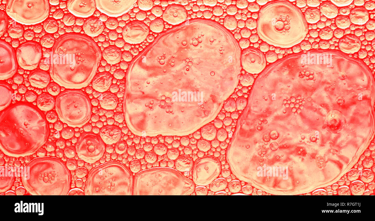 Colored abstract background in red tones, oil drops of different sizes placed on a water surface Stock Photo