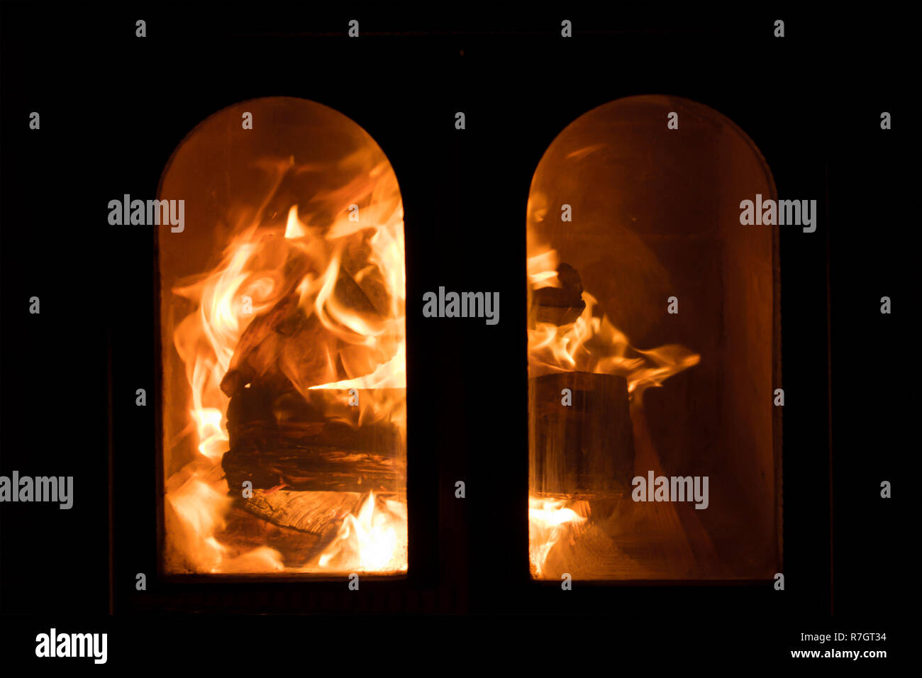 Raging Forks Of Flame In Fireplace Behind The Protective Glass