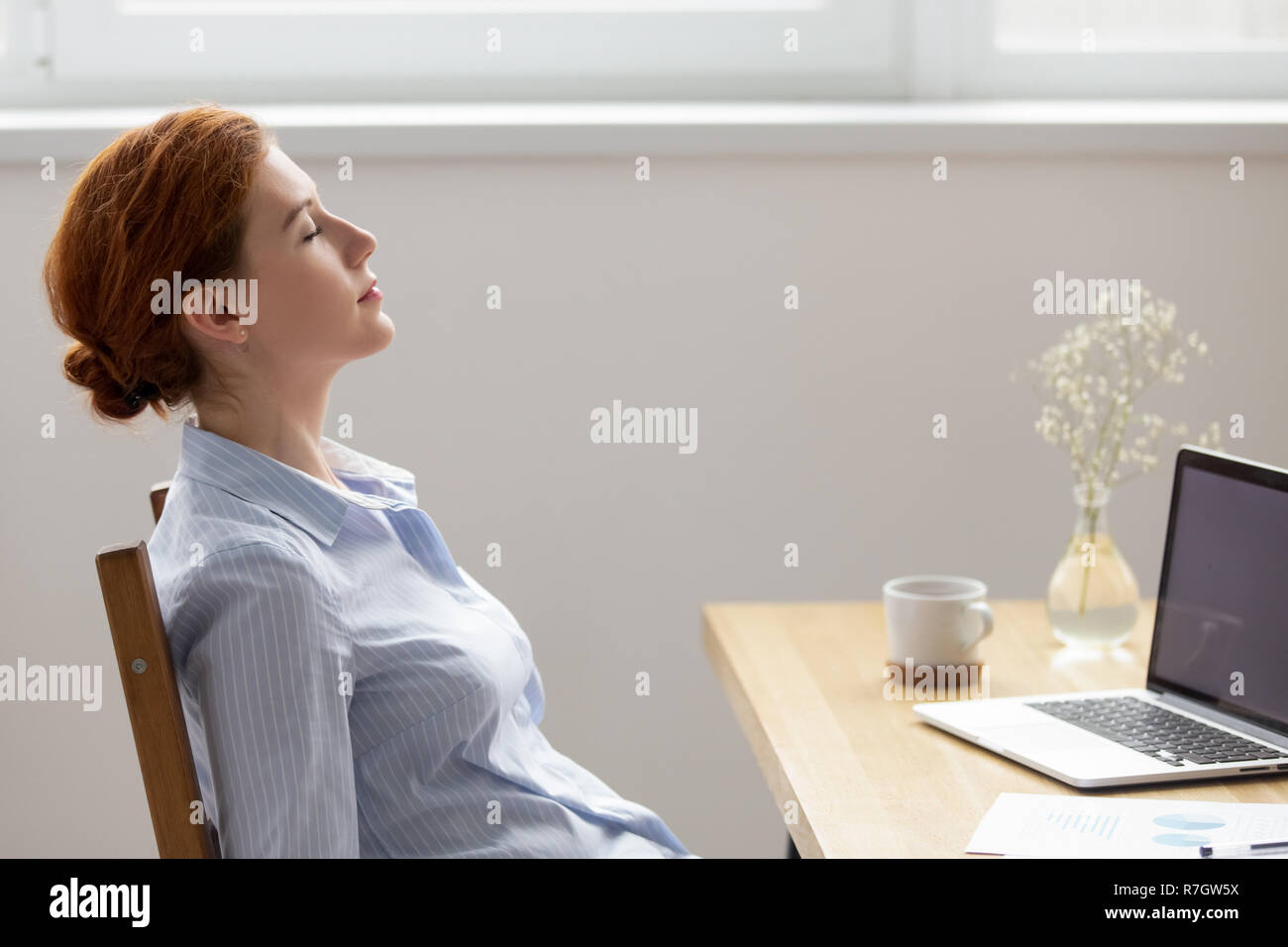Side View Female Resting With Closed Eyes At Work Stock Photo