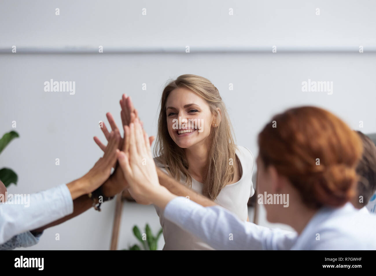 Businesspeople giving high five showing respect and togetherness Stock Photo