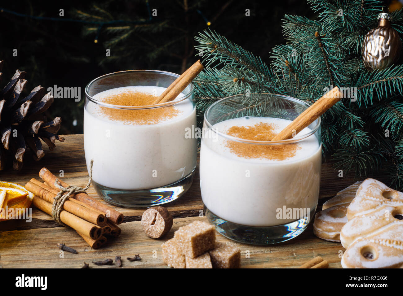 Eggnog (egg-nog), traditional Christmas winter drink with cinnamon, cloves and nutmeg. Homemade drinks. Winter Christmas mood. Stock Photo