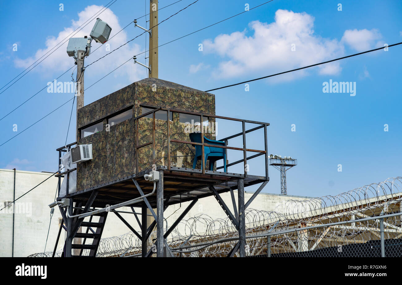 Not so Camo hut suspended on a metal frame gives guards a vantage point to watch inmates Stock Photo