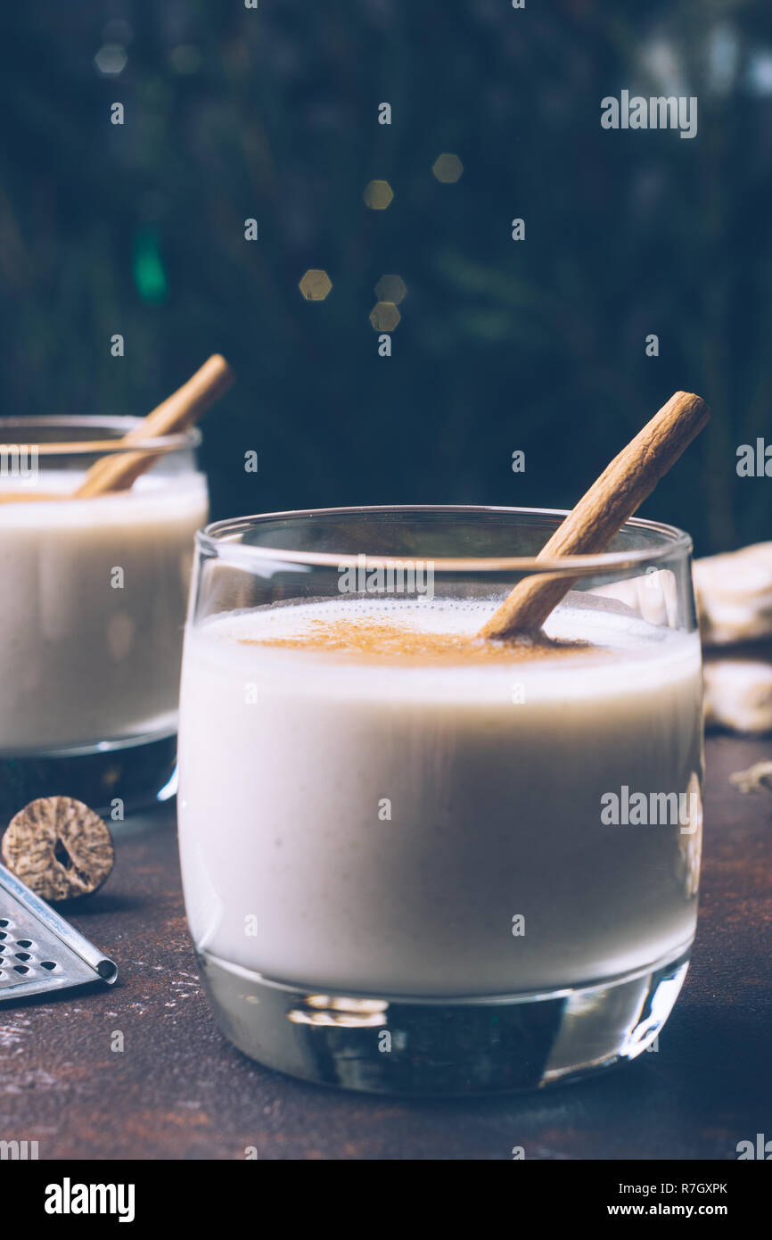 Eggnog (egg-nog), traditional Christmas winter drink with cinnamon, cloves and nutmeg. Homemade drinks. Winter Christmas mood. Stock Photo