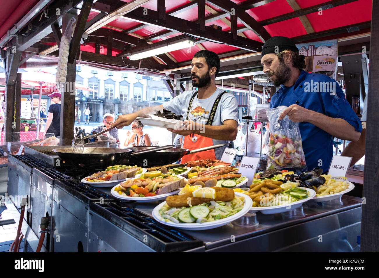 Bergen, Norway July 26th, 2018 Two cooks selling fried fish food at