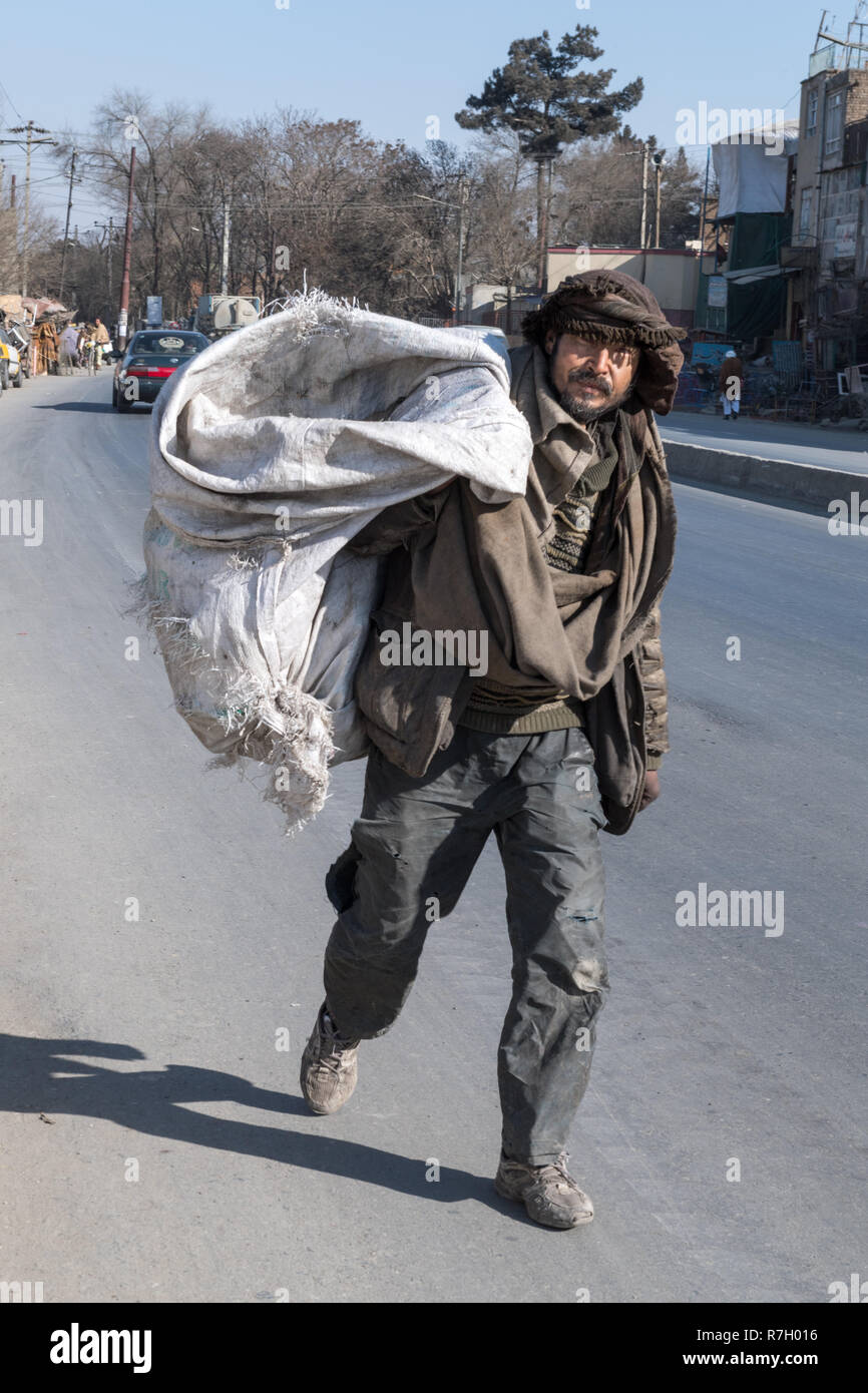 Garbage Collector With An Empty Bag In The Streets of Kabul, Kabul Province, Afghanistan Stock Photo