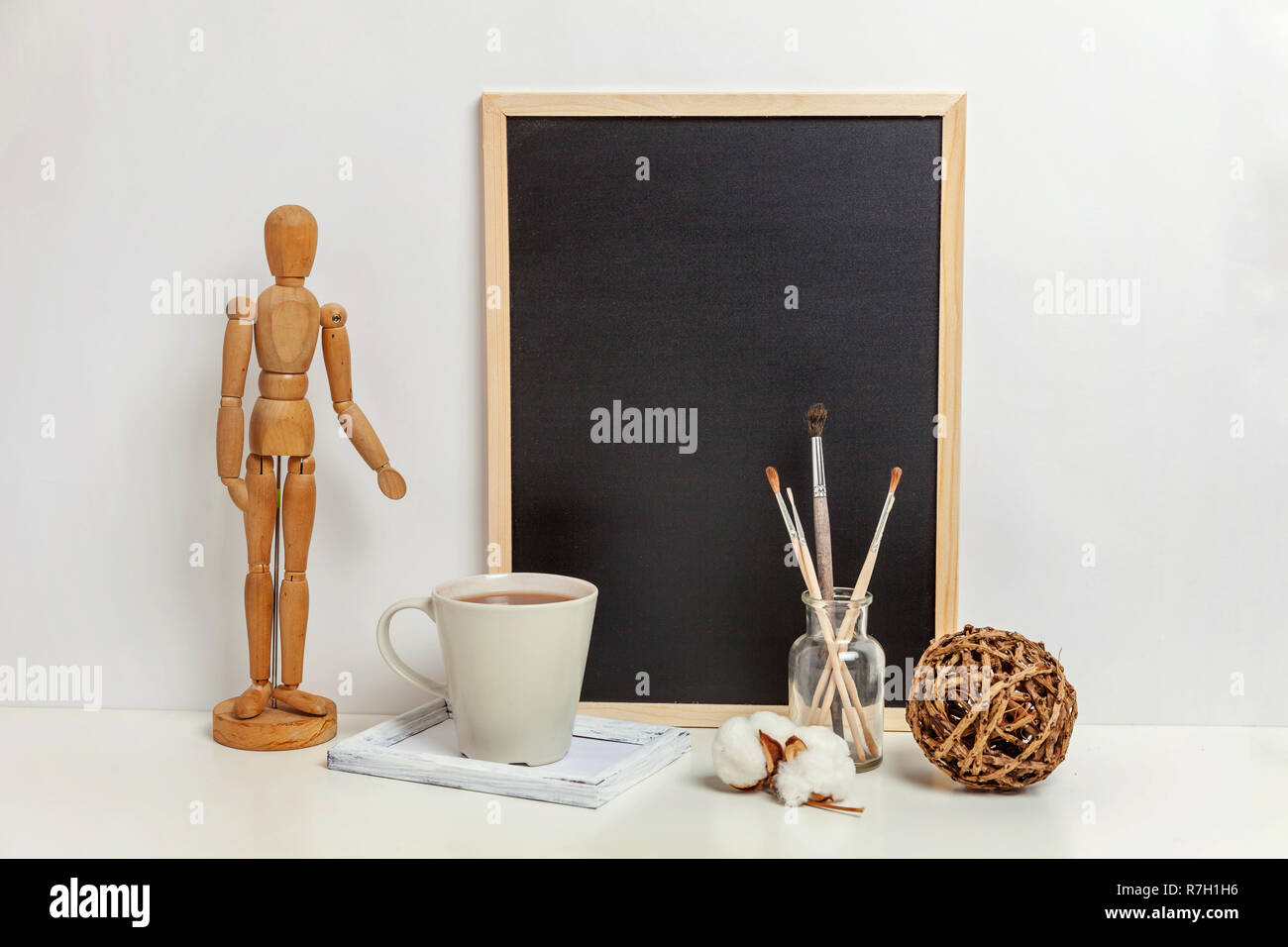 Home Or Office Decor With Mock Up Blank Chalkboard On Table