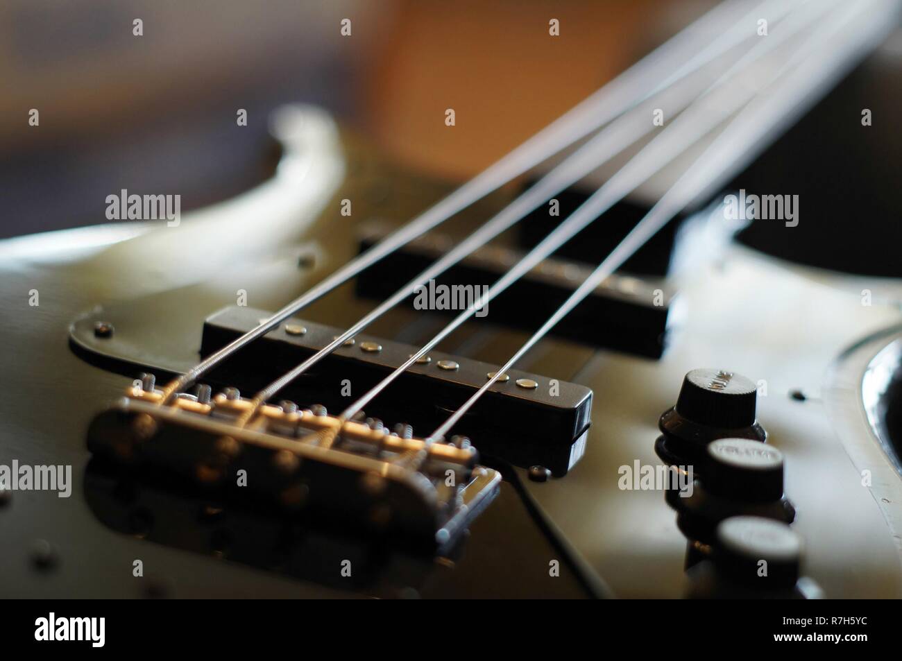 Closeup shot of a bass guitar bridge Fender Jazz Bass style bridge