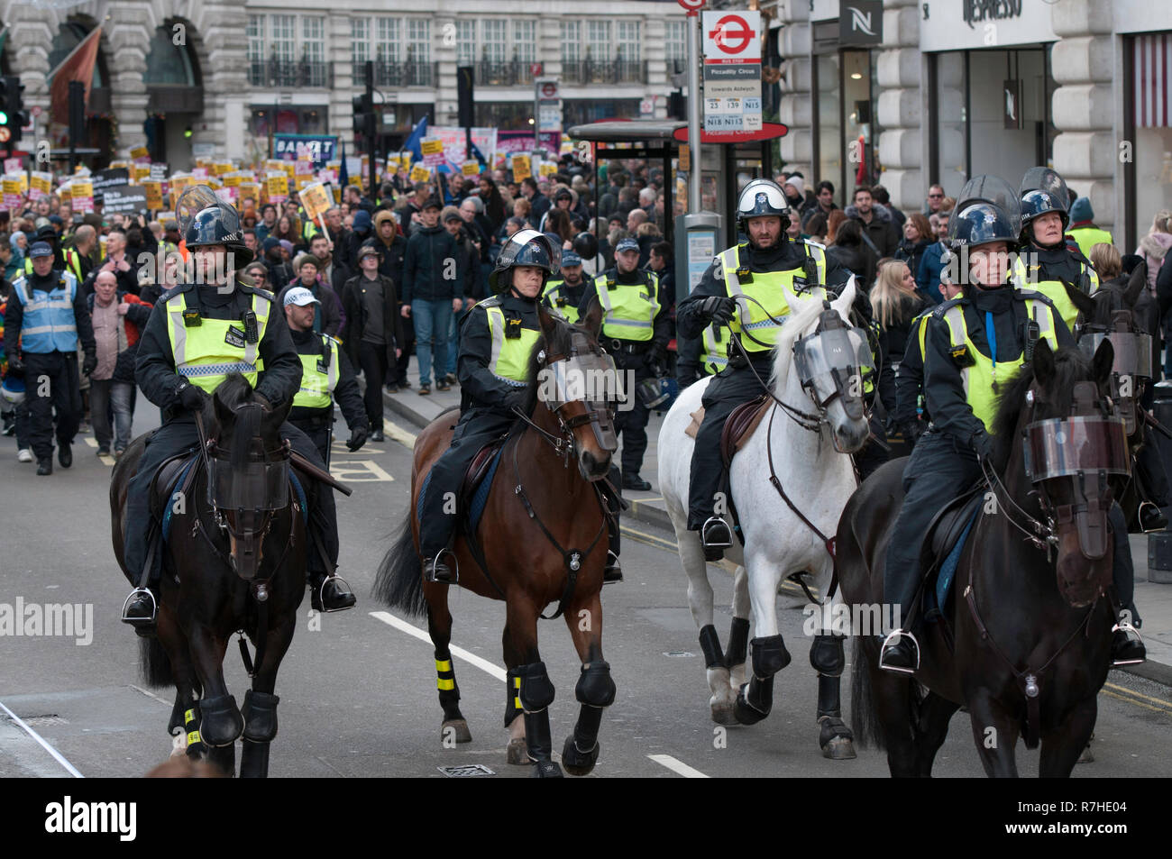 Mounted police officers stand in front of the march against Tommy Robinson.  Thousands of people took to the streets in central London to march against the 'Brexit Betrayal March' organised by Tommy Robinson and UKIP. Counter Protesters made their way from Portland Place to Whitehall, where speakers addressed the crowd. During the counter demonstration, there was a strong police presence. A group of counter protesters, who became separated from the main protest, were corralled by police to avoid an encounter with a group of Tommy Robinson / UKIP supporters. Stock Photo