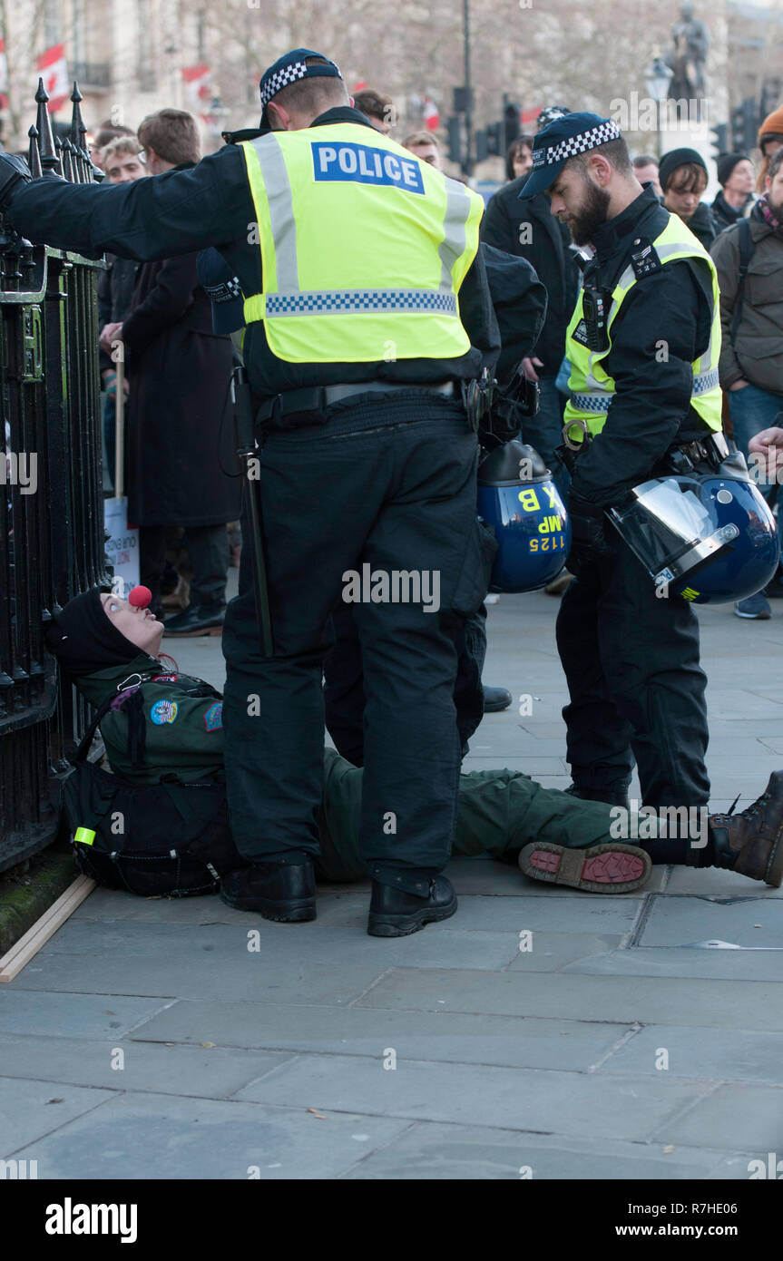 Police officers forcefully removed a counter-protester during a demonstration against the 'Brexit Betrayal March'.   Thousands of people took to the streets in central London to march against the 'Brexit Betrayal March' organised by Tommy Robinson and UKIP. Counter Protesters made their way from Portland Place to Whitehall, where speakers addressed the crowd. During the counter demonstration, there was a strong police presence. A group of counter protesters, who became separated from the main protest, were corralled by police to avoid an encounter with a group of Tommy Robinson / UKIP supporte Stock Photo