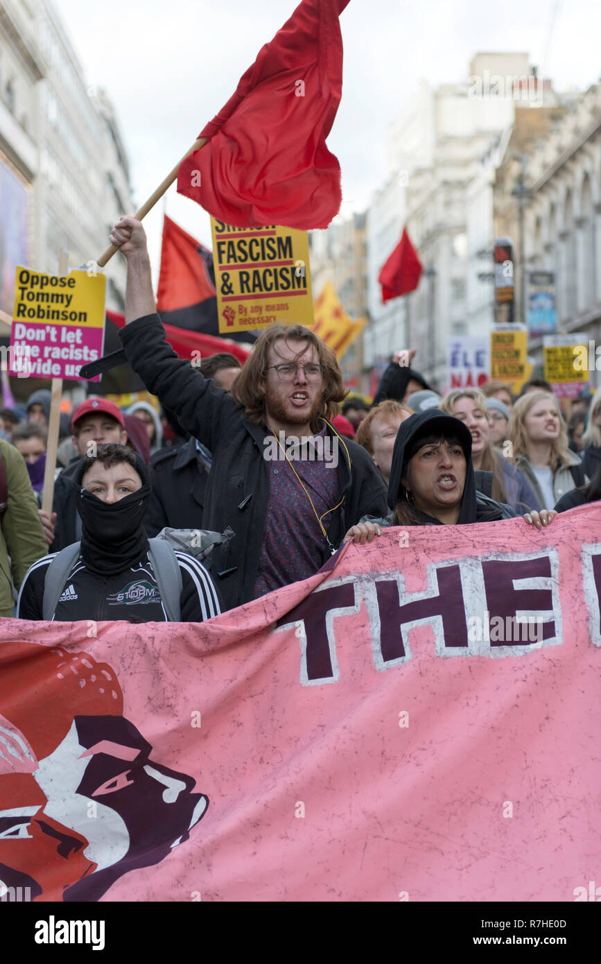 Counter protesters seen holding a banner and signs while shouting slogans during a demonstration against the 'Brexit Betrayal March'.   Thousands of people took to the streets in central London to march against the 'Brexit Betrayal March' organised by Tommy Robinson and UKIP. Counter Protesters made their way from Portland Place to Whitehall, where speakers addressed the crowd. During the counter demonstration, there was a strong police presence. A group of counter protesters, who became separated from the main protest, were corralled by police to avoid an encounter with a group of Tommy Robin Stock Photo