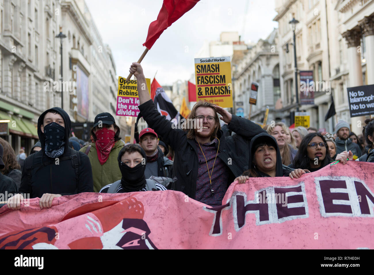 Counter protesters seen holding a banner and signs while shouting slogans during a demonstration against the 'Brexit Betrayal March'.   Thousands of people took to the streets in central London to march against the 'Brexit Betrayal March' organised by Tommy Robinson and UKIP. Counter Protesters made their way from Portland Place to Whitehall, where speakers addressed the crowd. During the counter demonstration, there was a strong police presence. A group of counter protesters, who became separated from the main protest, were corralled by police to avoid an encounter with a group of Tommy Robin Stock Photo