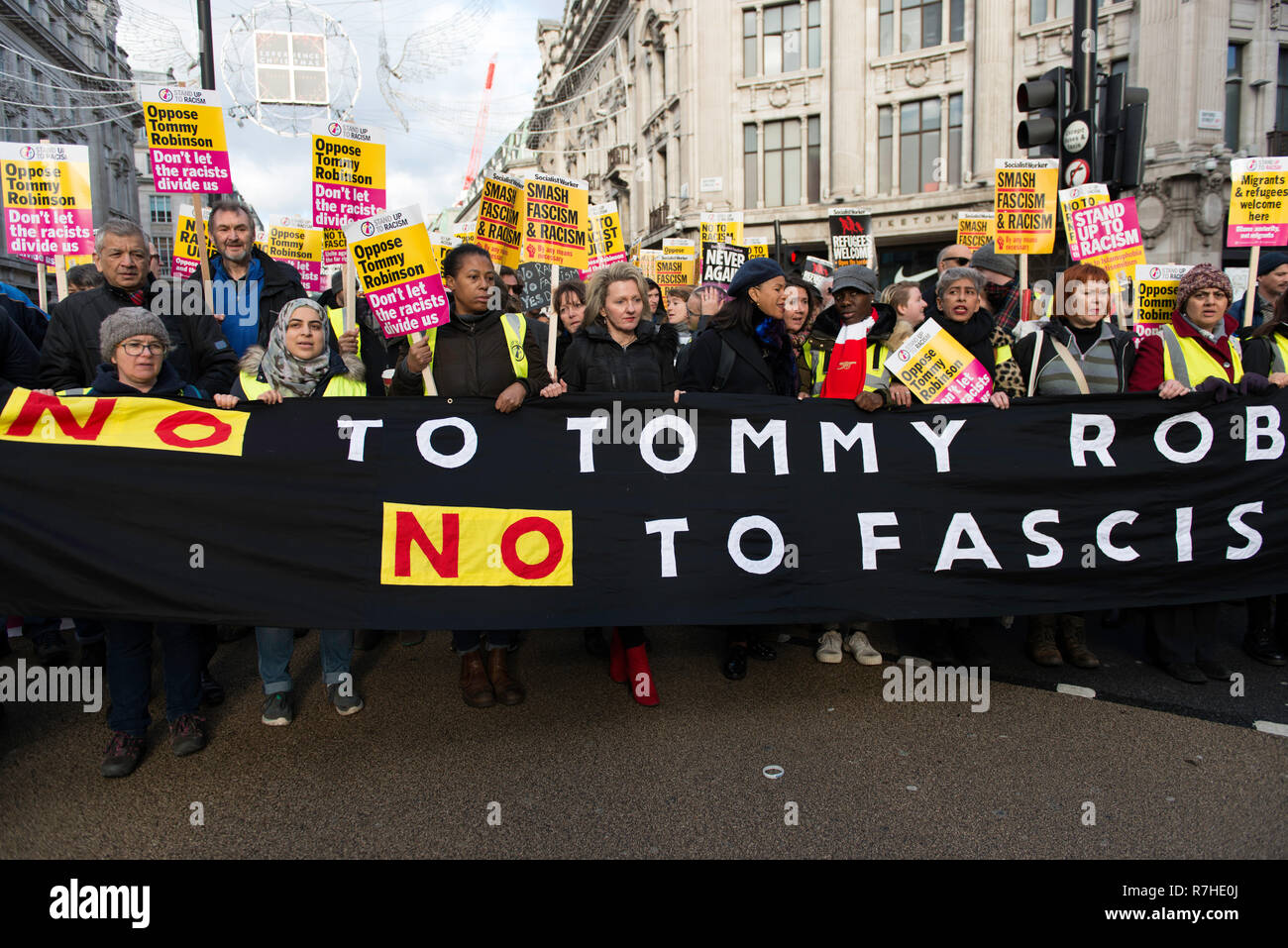 Counter protesters seen holding a large banner that reads 'No to Tommy Robinson, No to Fascism' during a demonstration against the 'Brexit Betrayal March'.  Thousands of people took to the streets in central London to march against the 'Brexit Betrayal March' organised by Tommy Robinson and UKIP. Counter Protesters made their way from Portland Place to Whitehall, where speakers addressed the crowd. During the counter demonstration, there was a strong police presence. A group of counter protesters, who became separated from the main protest, were corralled by police to avoid an encounter with a Stock Photo